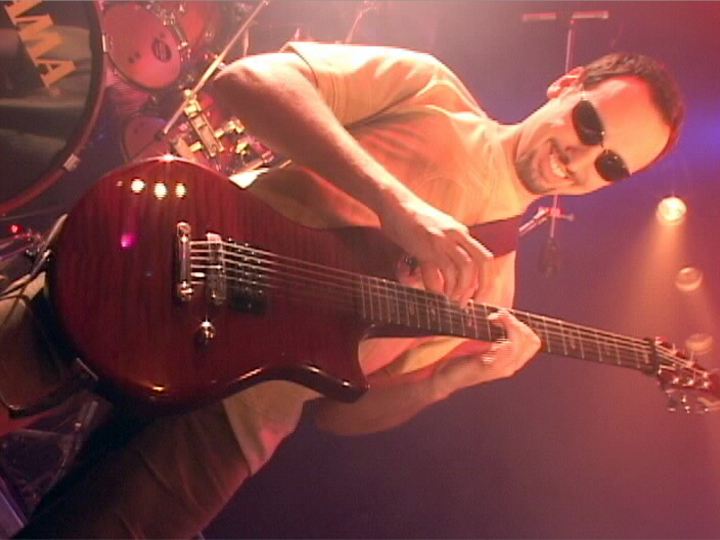 Aldo playing guitar on stage